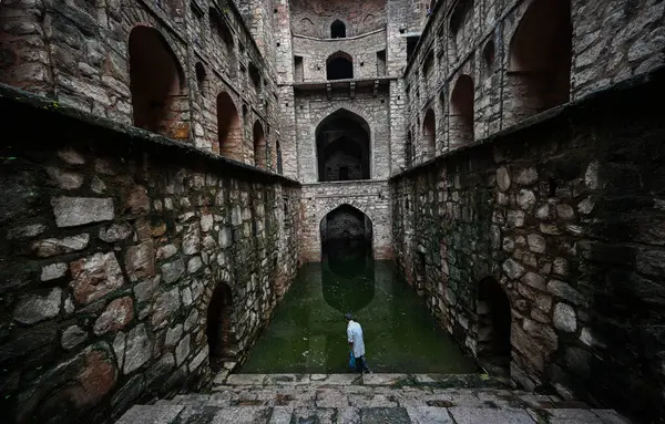 stock image NEW DELHI INDIA - SEPTEMBER 11:  Visitors enjoy at Historical landmark Ugrasen ki Baoli at Hailey Road near Connaught Place on September 11, 2024 in New Delhi, India 