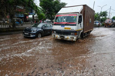 Due to rain for several days, big potholes have formed on Kulesara Road, a major accident can happen anytime, on September 13, 2024 in Greater Noida, India clipart