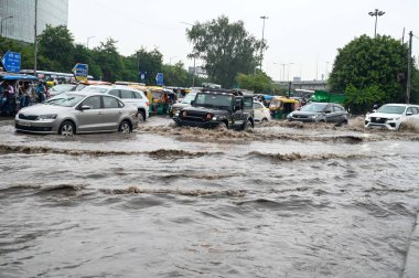 GURUGRAM, INDIA - SEPTEMBER 13, 2024: Due to heavy rain waterlogging at Iffco chowk on MG road near ABW tower in Gurugram, India. The India Meteorological Department (IMD) has issued an 'orange' alert, indicating a 