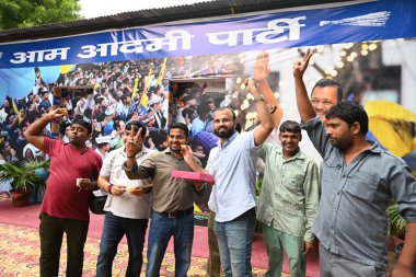 NEW DELHI, INDIA - SEPTEMBER 13: AAP leaders, MLAs and party workers celebrate the bail granted to Delhi CM Arvind Kejriwal by the Supreme Court in a corruption case registered by CBI in the alleged excise policy, at AAP Party office Pt. Ravi Shukla  clipart