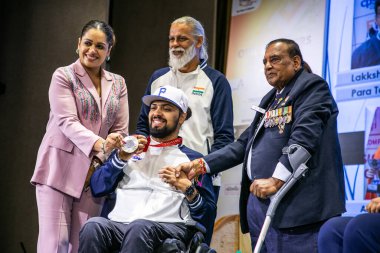 NEW DELHI INDIA SEPTEMBER 11 2024 Payal Kanodia Chairperson of YFLO Delhi Chapter 2024 25 wth Pranav Soorma won the silver medal in the mens club throw F51 event and Murlikant Petkar Swimming during a grand meet up of 7 Sporting Stars hosted by YFLO  clipart