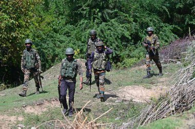 SRINAGAR INDIA SEPTEMBER 14 2024 Security forces at the encounter site at Chak Tapper area of Kreeri Pattan in North kashmirs Baramulla district some 35 kms from Srinagar on September 14 2024 in Srinagar India Three Militants were killed in an encoun clipart