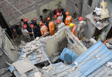 NEW DELHIINDIA SEPTEMBER 18 2024 NDRF and fire fitter Team Rescuse a Man at a Building Collpsed at Bapa Nagar Karol Bagh on September 18 2024 in New Delhi India. Four people died and 14 others sustained injuries when a five-storey building housing a  clipart