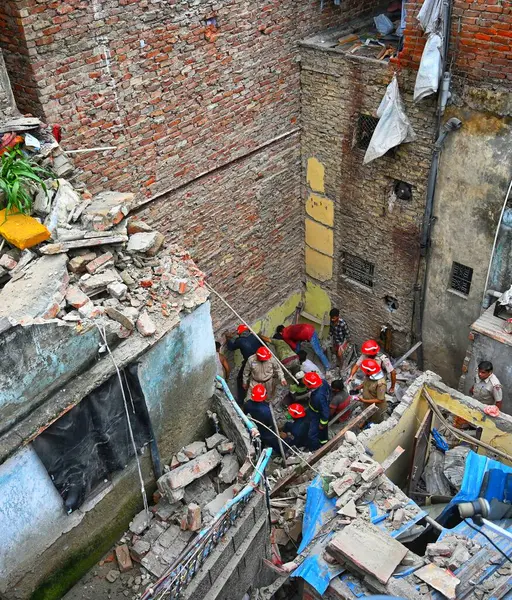 stock image NEW DELHIINDIA SEPTEMBER 18 2024 Rescue operation by NDRF and Fire personnel is underway at Bapa Nagar in Karol Bagh where a house collapsed in the morning on September 18 2024 in New Delhi India. Four people died and 14 others sustained injuries whe