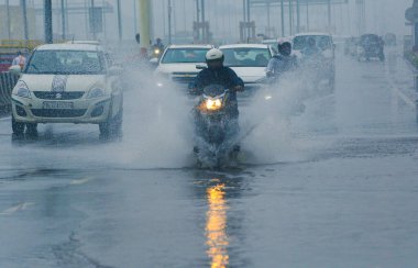 GHAZIABAD INDIA JULY 10 2023 Commuters wade through a water logged road at Dasna National Highway on July 10 2023 in Ghaziabad India Several parts of northwest India witnessed a heavy spell of rain breaking a 40 year old record It recorded 153 mm of  clipart