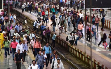 MUMBAI INDIA JULY 11 2023 Commuters wait on a platform to board a local train on World Population Day 2023 at CSMT on July 11 2023 in Mumbai India World Population Day is an annual event observed on July 11 every year which seeks to raise awareness o clipart