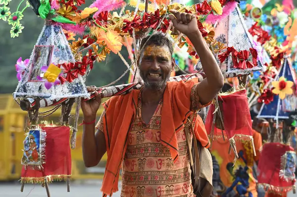 stock image NOIDA INDIA JULY 10 2023 Kanwariya carries holy water collected from Ganga River in Haridwar during Kanwar Yatra at Sector 14A on July 10 2023 in Noida India Kanwariyas devotees of Hindu God Shiva who carry holy water kanwarof the river Ganga from Ne