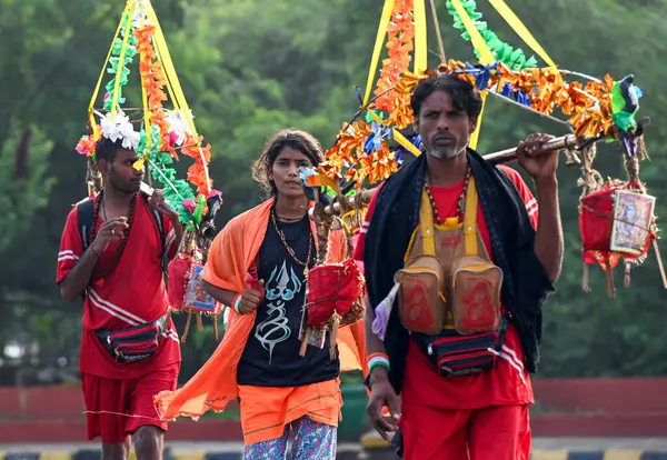 stock image NOIDA INDIA JULY 10 2023 Kanwariya carries holy water collected from Ganga River in Haridwar during Kanwar Yatra at Sector 14A on July 10 2023 in Noida India Kanwariyas devotees of Hindu God Shiva who carry holy water kanwarof the river Ganga from Ne