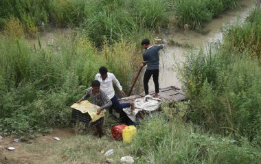 GHAZIABAD INDIA JULY 15 2023 Ghaziabad Hundreds of flood affected residents are staying put on the Alipur embankment as their houses and villages have been water locked by flood water from river Yamuna in Ghaziabads Loni on July 15 2023 in Ghaziabad  clipart