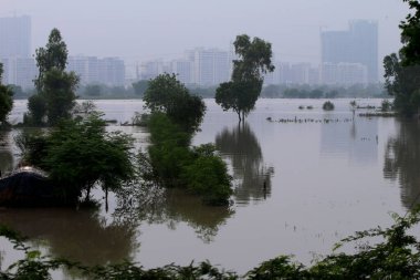 NEW DELHI INDIA JULY 15 2023 Flood water logged at Jaitpur Extension of Badarpur area near Yamuna flood plain Yamuna flood water enters Delhi road on July 15 2023 in New Delhi India The water level of the river has been rising since Wednesday after i clipart