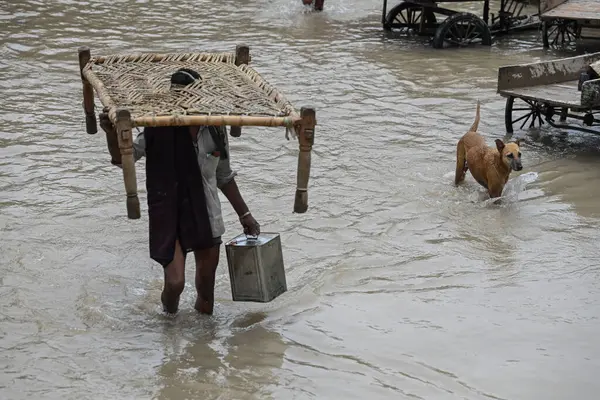 stock image NEW DELHI INDIA JULY 15 2023 People wade through a flooded road after the water level of the river Yamuna rose following heavy monsoon rains at Mayur Vihar Side on July 15 2023 in New Delhi India The water level of the river has been rising since Wed