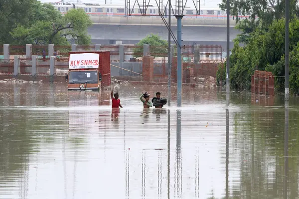 stock image NEW DELHI INDIA JULY 15 2023 People crossing in flood waterlogged at Nigam bodh Ghat on July 15 2023 in New Delhi India The water level of the river has been rising since Wednesday after it breached an all time high mark in more than 45 years Authori