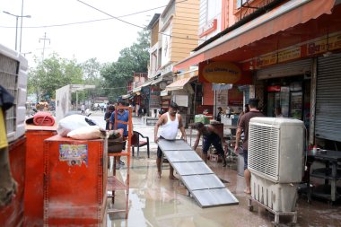 NEW DELHI INDIA JULY 16 2023 As the floodwater recede near Hanuman Mandir Jamuna Bazar shop owners and workers cleaning the shop to restart on July 16 2023 in New Delhi India The water level of the river has been rising since Wednesday after it breac clipart