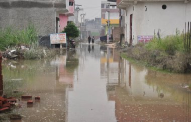 GHAZIABAD INDIA JULY 18 2023 A 19 year old man died of drowning in Lonis Ram Park colony which was flooded after last weeks breach at Alipur embankment people are forced to remain indoors or to the roof of their houses after water entered their homes clipart