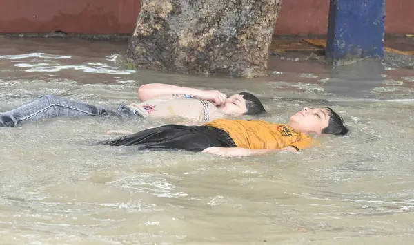 stock image NEW DELHI INDIA JULY 15 2023 People enjoying in flood water near Shantivan as the swollen Yamuna river inundates nearby areas on July 15 2023 in New Delhi India The water level of the river has been rising since Wednesday after it breached an all tim