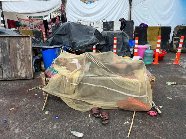 stock image NEW DELHI INDIA JULY 16 2023 Flood affected people are sleeping under mosquito net during early morning hours at a roadside tent opposite Mayur Vihar on July 16 2023 in New Delhi India The water level of the river has been rising since Wednesday afte