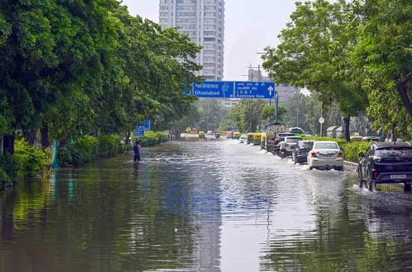 stock image NEW DELHI INDIA JULY 16 2023 Commuters move through the floodwaters of Yamuna river at ring road near WHO building on July 16 2023 in New Delhi India The water level of the river has been rising since Wednesday after it breached an all time high mark