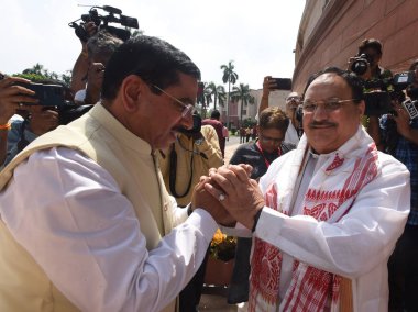 NEW DELHI INDIA JULY 20 2023 BJP National President and Rajya Sabha MP JP Nadda being greeted by Union Ministers Pralhad Joshi arrives at Parliament House complex on the first day of the Monsoon session of Parliament on July 20 2023 in New Delhi Indi clipart