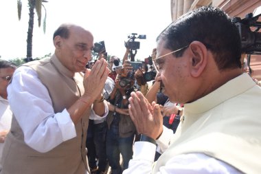 NEW DELHI INDIA JULY 20 2023 Defense Minister Rajnath Singh being greeted by Union Ministers Pralhad Joshi arrives at Parliament House complex on the first day of the Monsoon session of Parliament on July 20 2023 in New Delhi India Photo by Sonu Meht clipart