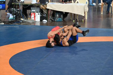 NEW DELHI INDIA JULY 23 2023 Vishal Kaliraman Red Jerseyin action at mens 65kg category during the Asian Games 2023 wrestling trials at IGI stadium on July 23 2023 in New Delhi India Photo by Sanjeev Verma Hindustan Times clipart