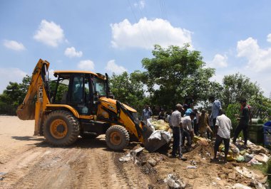 NEW DELHI INDIA JULY 24 2023 Labour workers fill bags to make tempers near the Yamuna river flows high at ITO on July 24 2023 in New Delhi India Photo by Sonu Mehta Hindustan Times clipart