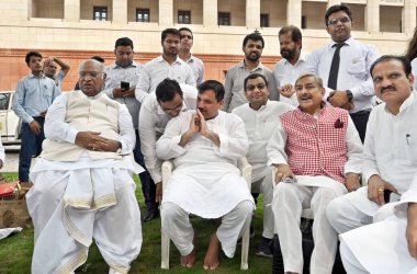 NEW DELHI INDIA JULY 25 2023 Leader of Opposition in Rajya Sabha Mallikarjun Kharge with Congress MP Pramod Tiwari and Aam Aadmi Party AAPMP Sanjay Singh during the sit in protest against the latters suspension from the Rajya Sabha for the entire mon clipart