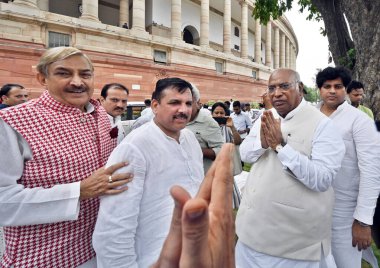 NEW DELHI INDIA JULY 25 2023 Leader of Opposition in Rajya Sabha Mallikarjun Kharge with Congress MP Pramod Tiwari and Aam Aadmi Party AAPMP Sanjay Singh during the sit in protest against the latters suspension from the Rajya Sabha for the entire mon clipart