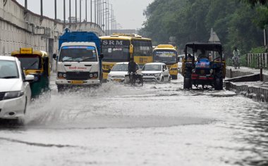 NEW DELHI INDIA JULY 26 2023 Vehicles wade through a Waterlogged stretch near Mayur Vihar Phase 2 during monsoon rain on July 26 2023 in New Delhi India The residents of Delhi NCR witnessed heavy rainfall Commuters faced problems due to waterlogging  clipart