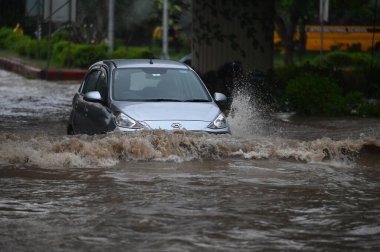 NOIDA INDIA JULY 26 2023 Commuters pass through a heavily waterlogged stretch of road at Sector 44 on July 26 2023 in Noida India The residents of Delhi NCR witnessed heavy rainfall Commuters faced problems due to waterlogging in several areas The IM clipart