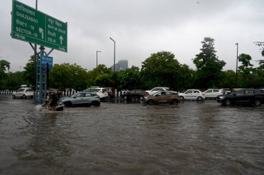 NOIDA INDIA JULY 26 2023 Commuters pass through a heavily waterlogged stretch of road at Sector 95 on July 26 2023 in Noida India The residents of Delhi NCR witnessed heavy rainfall Commuters faced problems due to waterlogging in several areas The IM clipart