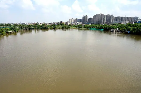 stock image GREATER NOIDA INDIA JULY 24 2023 People from low lying areas around the Hindon river wade through flood waters of the swollen river while relocating to a safer place at Purana Haibatpur village on June 24 2023 in Greater Noida India Photo by Sunil Gh