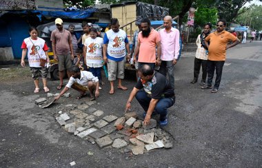 MUMBAI INDIA JULY 29 2023 The Members of Watchdog foundation feeding Debris in a Potholes on Sahar Village at Andheri on July 29 2023 in Mumbai India Photo by Vijay Bate Hindustan Times clipart