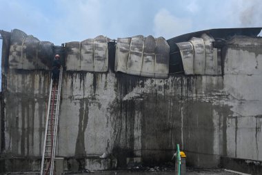 NEW DELHI INDIA JULY 30 2023 Firemen douse the fire that broke out at a footwear factory in west Delhi Udyog Nagar near Peera Garhi Chowk in the morning Four fire tenders were rushed to the site and an operation clipart