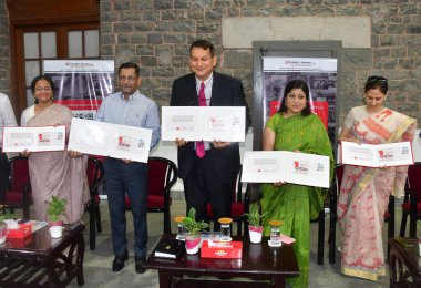 MUMBAI INDIA SEPTEMBER 25 2024 Chief Postmaster General Maharashtra Amitabh Singh and Project Mumbai founder Shishir Joshi releasing a special stamp cover on Change through Volunteerism commemorating the spirit of volunteers and DaanUtsav at the GPO  clipart