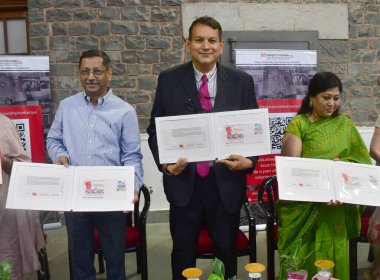 MUMBAI INDIA SEPTEMBER 25 2024 Chief Postmaster General Maharashtra Amitabh Singh and Project Mumbai founder Shishir Joshi releasing a special stamp cover on Change through Volunteerism commemorating the spirit of volunteers and DaanUtsav at the GPO  clipart