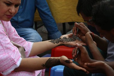 NEW DELHI INDIA AUGUST 18 2023 Indian women getting her hands decorated with mehandi Henna on the ocassion of Hariyali Teej Festival at Lajpat Nagar on August 18 2023 in New Delhi India Photo by Salman Ali Hindustan Times clipart