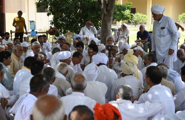 PALWAL INDIA AUGUST 18 2023 Leaders of 52 paal seen during a Panchayat regarding Brij Mandal Yatra in presence of the members of Muslim Communities in Bhavye Vatika at Mandkola village Palwal district on August 18 ,2023 in Palwal, India  clipart