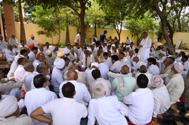 PALWAL INDIA AUGUST 18 2023 Leaders of 52 paal seen during a Panchayat regarding Brij Mandal Yatra in presence of the members of Muslim Communities in Bhavye Vatika at Mandkola village Palwal district on August 18 ,2023 in Palwal, India  clipart