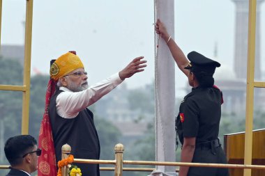 NEW DELHI INDIA AUGUST 15 2023 Prime Minister Narendra Modi unfurling the National flag during the nations 77th Independence Day at Red Fort on August 15 2023 in New Delhi India Narendra Modi said that India helped different countries during the time clipart