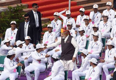 NEW DELHI, INDIA AUGUST 15 2023: Prime Minister Narendra Modi meets with NCC Cadets during the 77th Independence Day function at the historic Red Fort on August 15 2023 in New Delhi India. clipart