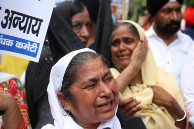 NEW DELHI INDIA AUGUST 5 2023 Survivors and families of 1984 Sikh riots are protesting outside Rouse Avenue Court to demand for justice after Delhi court grants anticipatory bail to Jagdish Tytler on August 5 2023 in New Delhi India Tytler on Saturda clipart