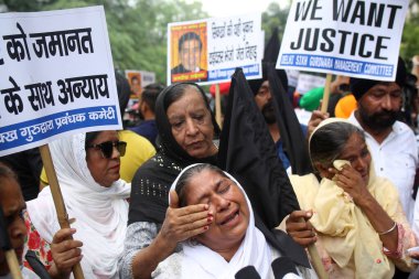 NEW DELHI INDIA AUGUST 5 2023 Survivors and families of 1984 Sikh riots are protesting outside Rouse Avenue Court to demand for justice after Delhi court grants anticipatory bail to Jagdish Tytler on August 5 2023 in New Delhi India Tytler on Saturda clipart