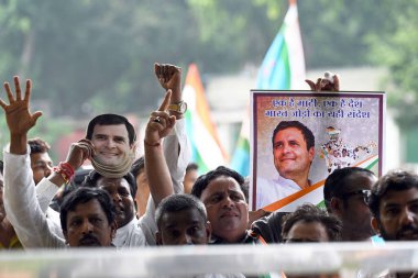 NEW DELHI INDIA AUGUST 4 2023 Congress workers raise slogans in support of party leader Rahul Gandhi to celebrate after the Supreme Court stayed the conviction of Gandhi in the 2019 criminal defamation case over his Modi surname remark restoring his  clipart