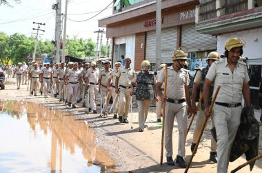 GURUGRAM INDIA AUGUST 1 2023 Police personnel conduct a flag march due to security reasons at Nuh near Bus Stand on August 1 2023 in Nuh India Five people were killed and over 50 people including policemen were injured in Haryana after clashes broke  clipart