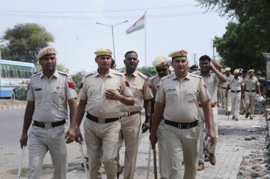 GURUGRAM INDIA AUGUST 1 2023 Police personnel conduct a flag march due to security reasons at Nuh near Bus Stand on August 1 2023 in Nuh India Five people were killed and over 50 people including policemen were injured in Haryana after clashes broke  clipart