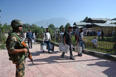 BANDIPORA INDIA SEPTEMBER 30 SEPTEMBER 30 2024 Anket görevlileri Bandipora Hindistan 'ın Sumbal alanında 30 Eylül 2024 tarihinde yapılan parlamento seçimlerinin üçüncü ve son safhasında EVM' yi dağıtım merkezinde taşıyorlar.