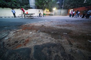 NEW DELHI INDIA SEPTEMBER 30 2024 Potholes seen over road near NSIC Complex as Atishi Chief Minister of Delhi seen along with PWD officials inspects the condition of Outer Ring Road at Kalkaji on September 30 2024 in New Delhi India Chief Minister in clipart