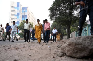 NEW DELHI INDIA SEPTEMBER 30 2024 Delhi Chief Minister Atishi inspecting potholes on road the bad condition of road near NSIC Kalka Ji road along with PWD officials on September 30 2024 in New Delhi India Chief Minister inspected and identified damag clipart