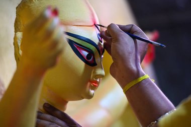 NOIDA INDIA OCTOBER 3 2024 An artist gives finishing touches to an idol of Hindu goddess Durga Goddess Lakshmi Goddess Saraswati Lord Kartik Lord Ganesha and Mahishasura ahead of the Durga Puja festival in Sector 31 on October 3 2024 in Noida India P