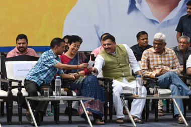 NEW DELHI INDIA OCTOBER 6 2024 AAP leader and Delhi former Chief Minister Arvind Kejriwal Delhi CM Atishi along with party leaders during the public meeting Janta Ki Adalat to engage with the people at Chhatrasal Stadium on October 6 2024 in New Delh clipart